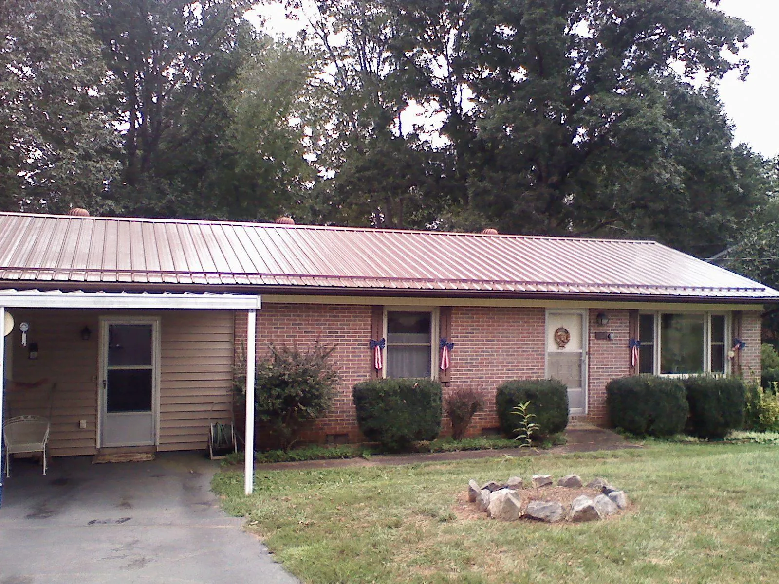 Bronze metal roof and carport on a brick ranch home — Roof Repair work by our crew in New Providence