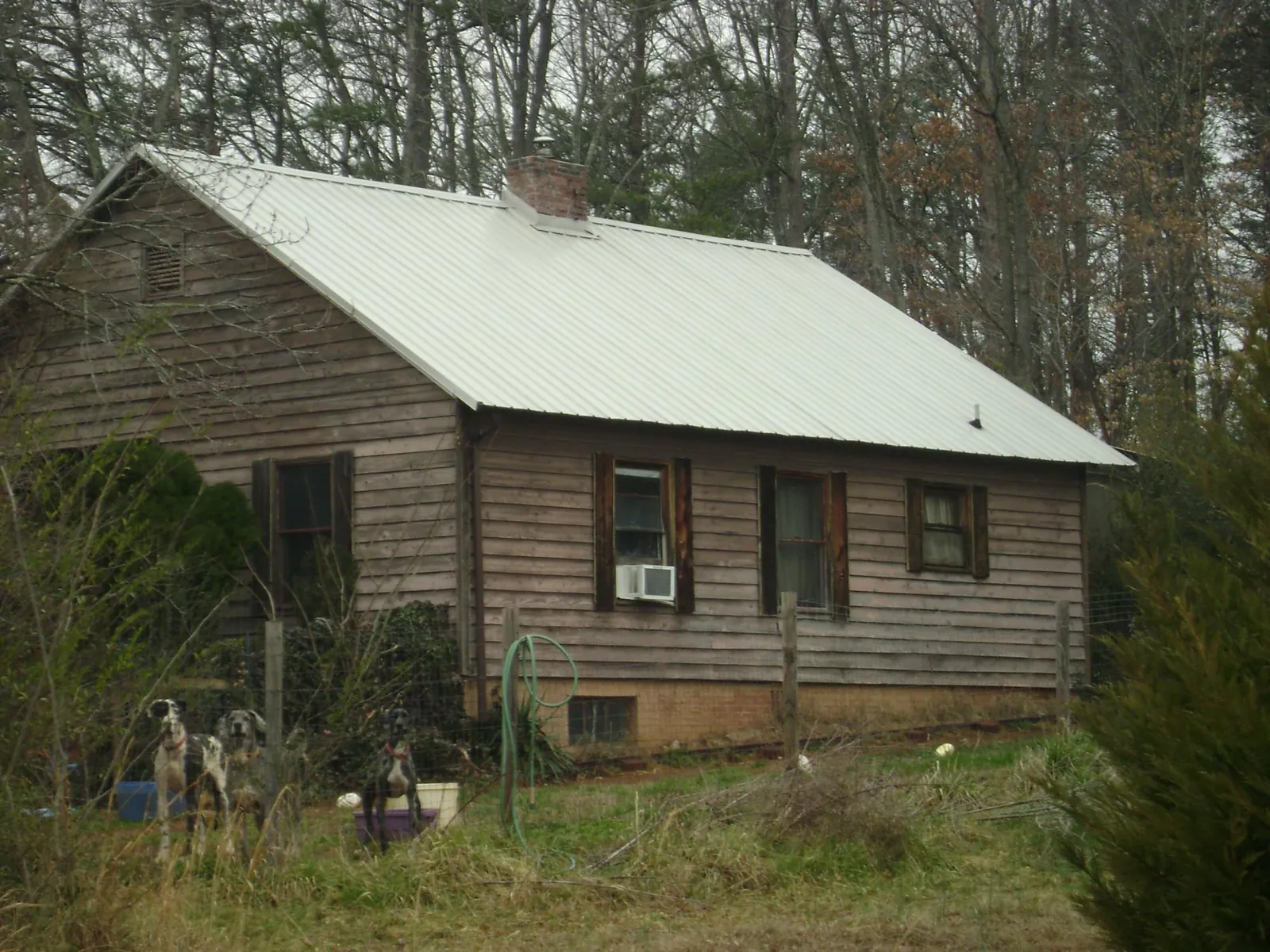 White metal roof on an old wood sided farmhouse, from a Metal Roof Installation job in New Providence